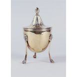 A silver lidded cup on three legs with lion masquerades, standing on claw feet, the lid with acorn-s