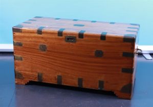 A colonial military camphor chest with recessed copper fittings and candle compartment on the inside