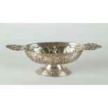 A silver oval brandy bowl, with hand-carved decoration of cattle figures, with flat ears with decora