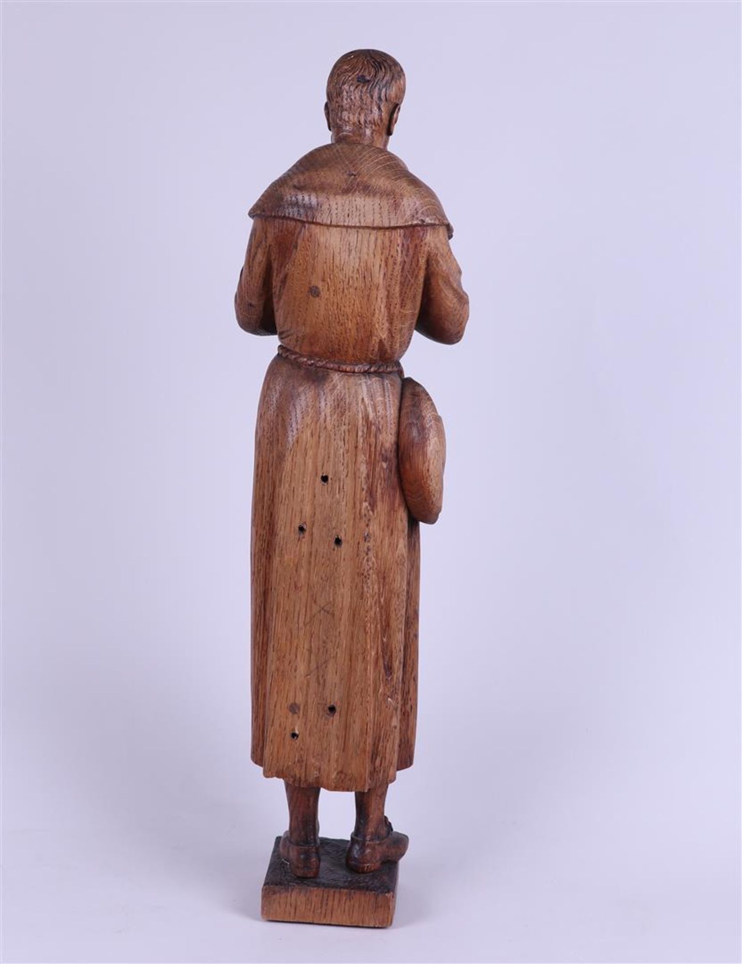 An oak sculpture of a pilgrim.
 - Image 4 of 5