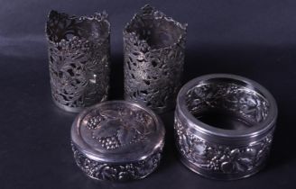 A lot consisting of (2) silver holders for an oil and vinegar set, a silver-plated jam lid, and a di