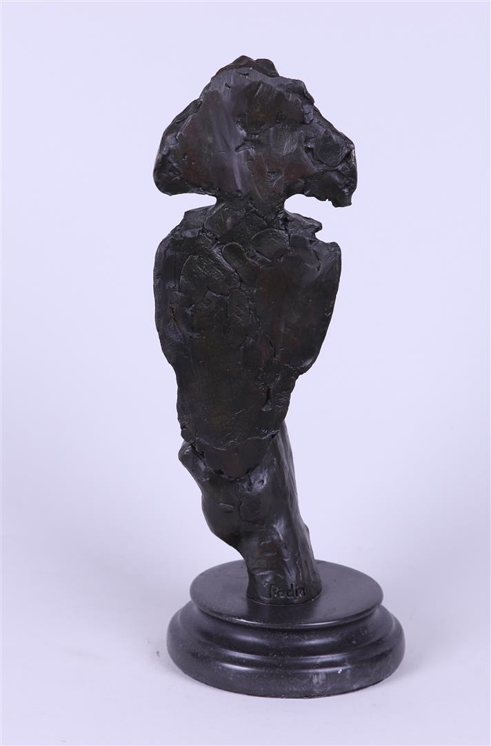 A bronze sculpture of a man calling for silence.  - Image 2 of 3
