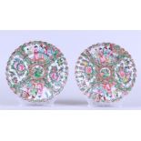 Two porcelain Canton plates with flowerbed decor depicting figures at a pavilion and floral decorati