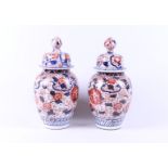 A pair of Imari lidded vases. Japan
