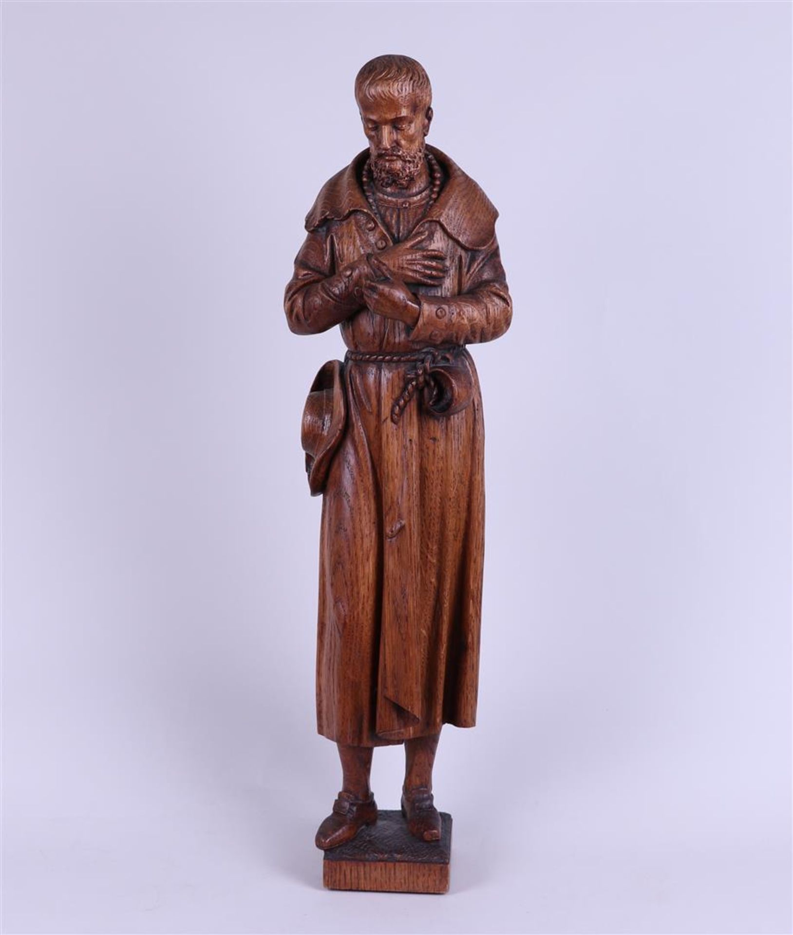 An oak sculpture of a pilgrim.
