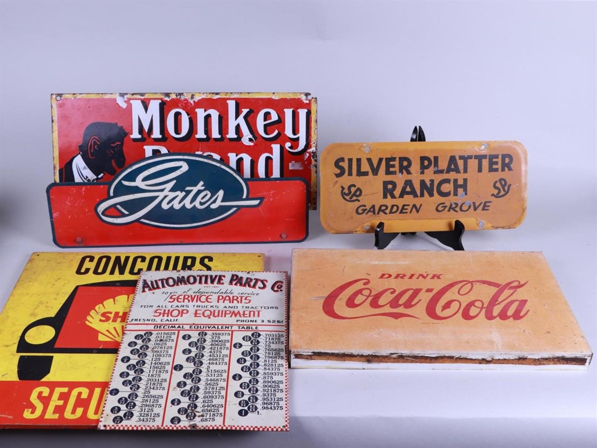 A lot of various vintage iron and cardboard partly advertising signs including Coca Cola.