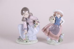 A lot with two porcelain figures of girls picking flowers.
