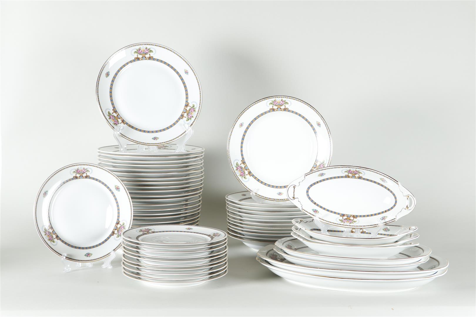 An extensive dinner set with floral decoration. 
