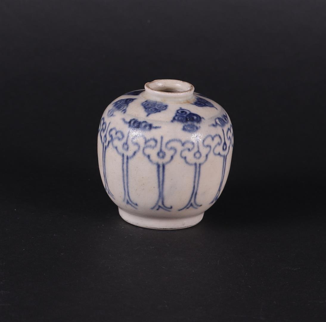 A stoneware small model cream jar with underglaze blue cloud decoration. China, 17th/18th century.
