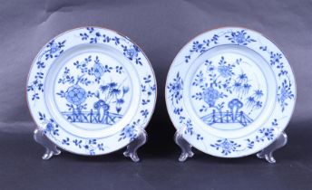 Two porcelain plates with floral decor in the outer rim. The center with bamboo, chrysanthemum and f