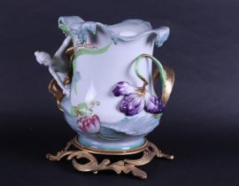 A porcelain Art Noveau style vase with brass base, marked Sèvres.
