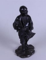 A pewter Okimono statue of a farmer. Japan, 20th century.