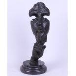 A bronze sculpture of a man calling for silence. 