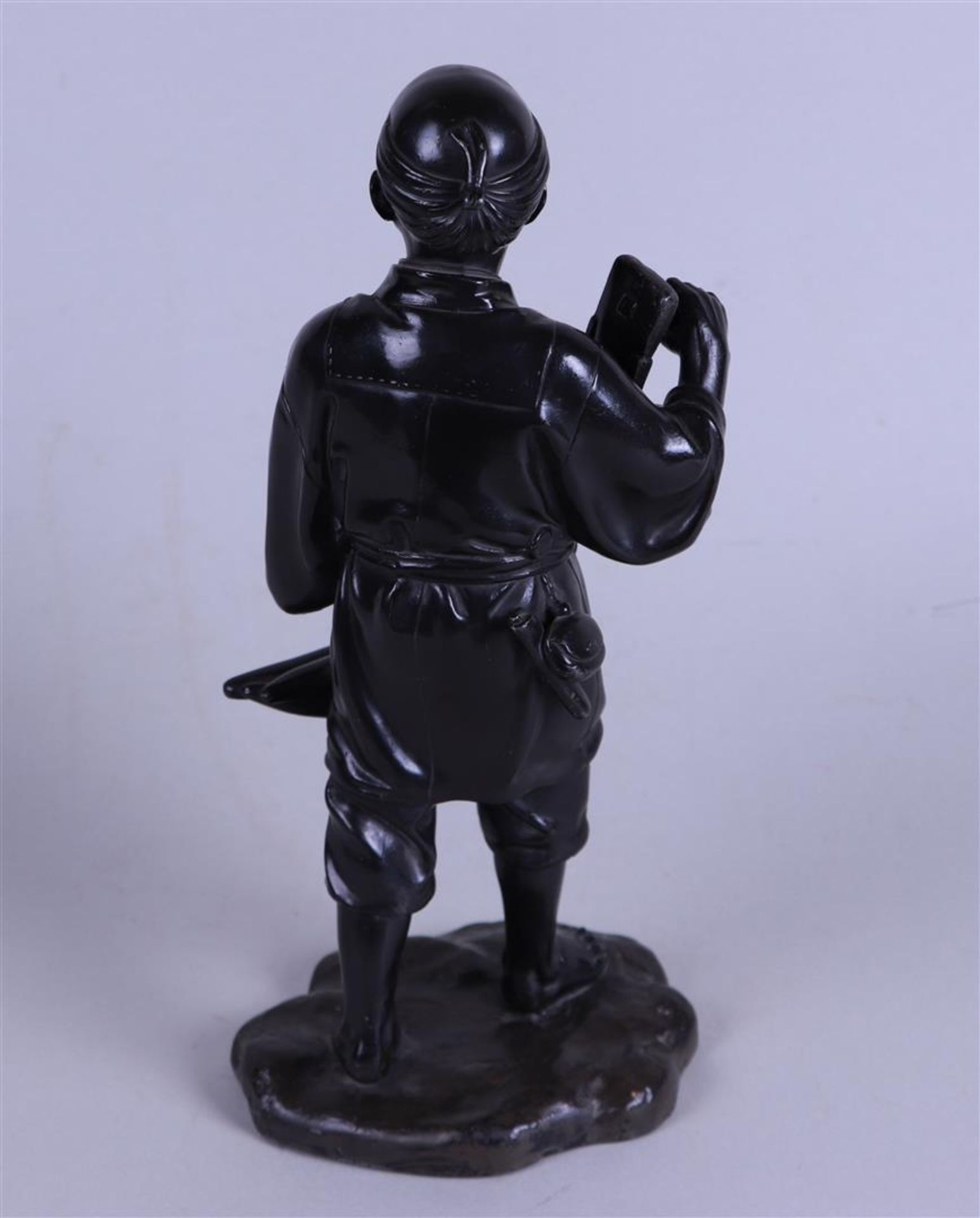 A pewter Okimono statue of a farmer. Japan, 20th century.
 - Image 2 of 3