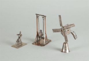 A lot comprising (3) silver miniatures, including a windmill, a cyclist, and a rocker