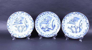 A set of three porcelain dishes with a decor of a figure in a landscape. China, Yongzheng.