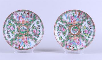 Two porcelain Canton plates with flowerbed decor depicting figures at a pavilion and floral decorati