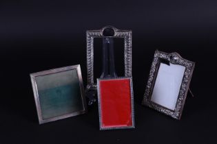 A lot of four silver photo frames.