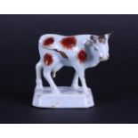 A "Delft" red-and-white cow, 18th century. 