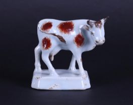 A "Delft" red-and-white cow, 18th century. 