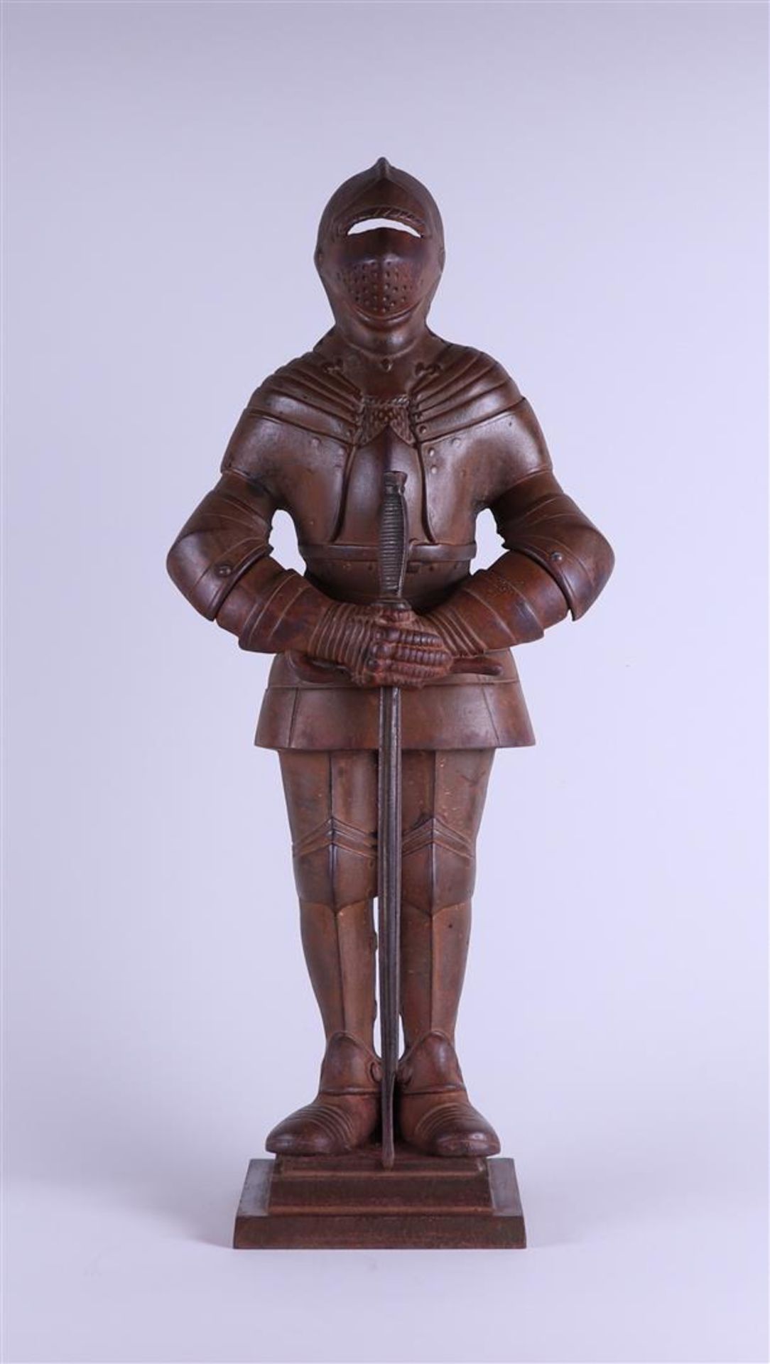 A cast iron sculpture of a soldier, marked 'a opreij maastricht' on the back.