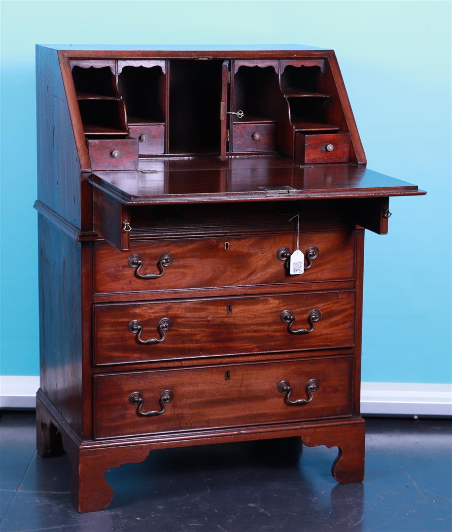 A flap secretary with four drawers and brass fittings, after an older English example.
