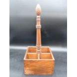 A hardwood four division Bottle Holder with central handle having carved finial, 18in