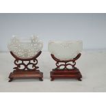 Two 19th Century carved and pierced Jade pieces on carved hardwood stands, approx 3in x 2in