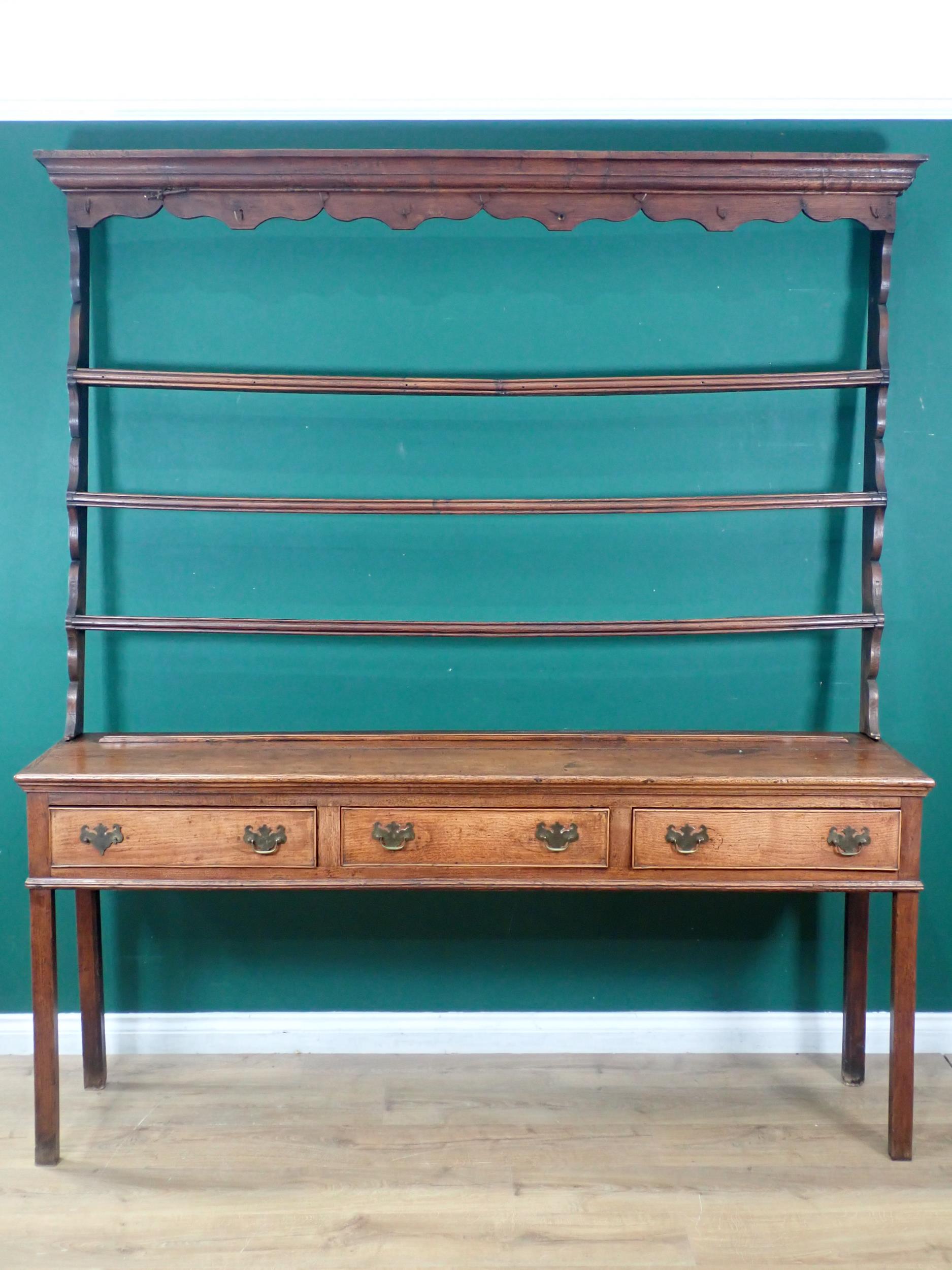 An 18th Century Shropshire oak Dresser and Rack, the base fitted three frieze drawers and raised