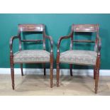 A pair of Regency mahogany Elbow Chairs with brass inlaid bar backs, rope twist horizontal rails,