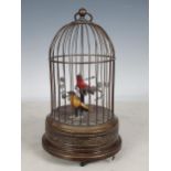An early 20th Century Continental singing bird Automaton with two song birds on branch with foliage,