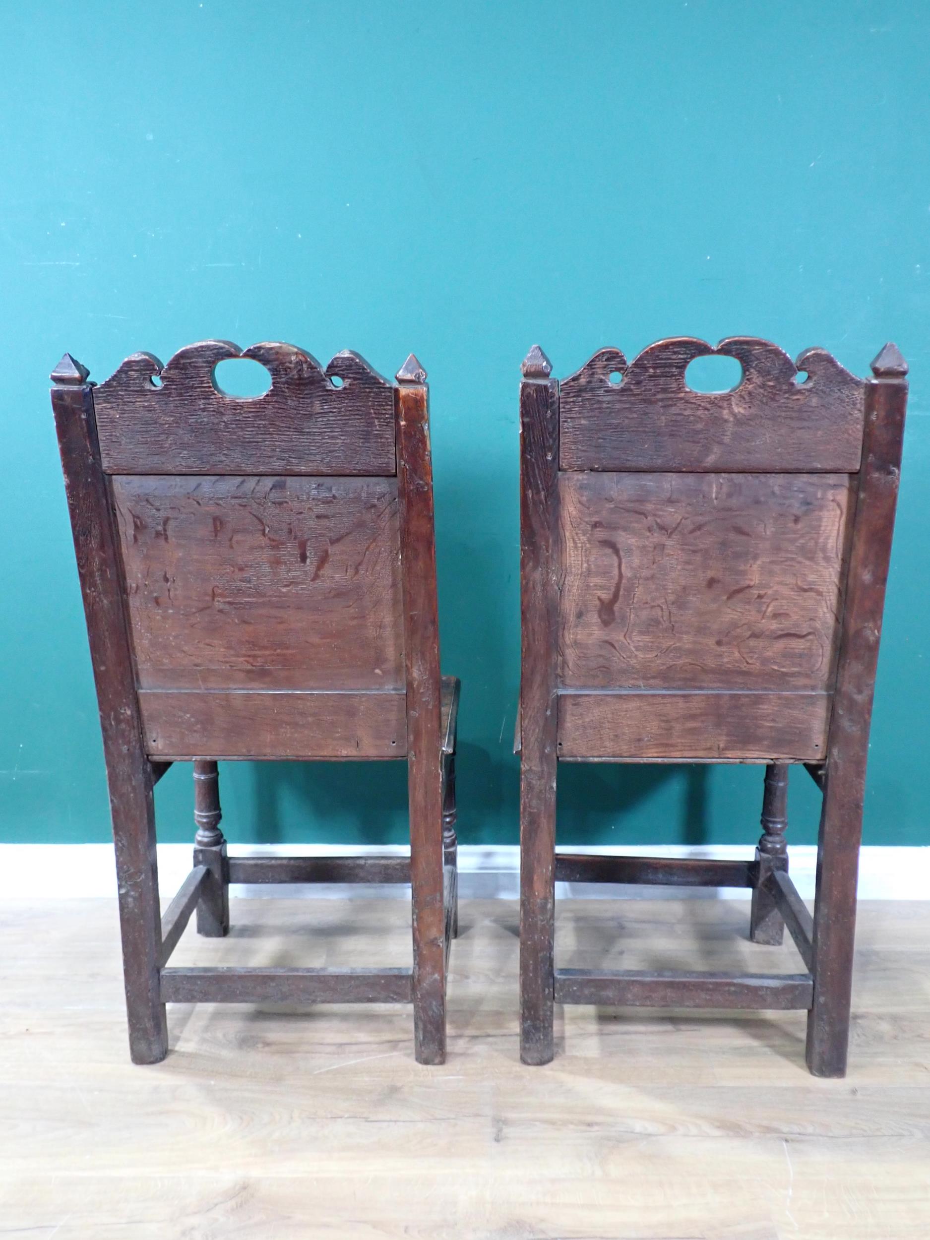 A pair of 17th Century oak Hall Chairs with pierced shaped crests above foliate carved panel - Image 5 of 6