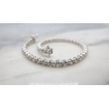 A Diamond Tennis Bracelet having forty six articulated links each claw-set brilliant-cut diamond,