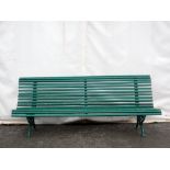 A green painted Garden Bench with wooden slats on cast iron leafage and scroll supports 6ft 9in W
