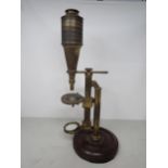 A 19th Century brass Microscope inscribed J. Dancer, Liverpool, with adjustable table and mirror, on