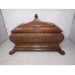 A 20th Century oak Casket of sarcophagus shape, carved with coat of arms, initials JSA 1934,