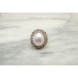 A Cultured Pearl and Diamond Cluster Ring the pale rosé pearl within a frame of millegrain-set old-