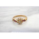 A 19ct Century Diamond, Seed Pearl and Ruby Ring claw-set old-cut diamond within frame of seed
