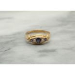 A Sapphire and Pearl Ring pavé-set three graduated round sapphires interspersed with two seed pearls