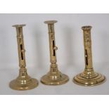 A pair of 18th Century brass Ejector Candlesticks of barrel form on circular bases 7 1/2in H and