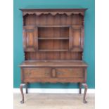 An oak Dresser and Rack with shaped frieze above two small cupboards and shelves, the base fitted