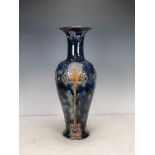 A Royal Doulton Vase of baluster form, decorated stylised foliage, in brown glazes on a blue ground,