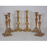 A set of four 19th Century brass Candlesticks of slender baluster form on square bases 9 1/2in H and