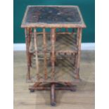 A late 19th Century bamboo Revolving Bookcase, the top decorated with chinoiserie design of birds