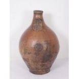 A 17th Century stoneware salt glazed Bellarmine Wine Jug with orange tiger glaze and mask decoration