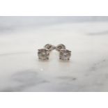 A pair of Diamond Ear Studs each claw-set brilliant-cut stone , total diamond weight 1.01cts, in