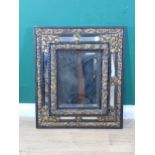 A Dutch repoussé Wall Mirror with central bevelled plate surrounded by floral embossed brass and