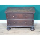 An early 18th Century oak Child's Chest fitted two long drawers raised on bun front feet, 2ft 4in