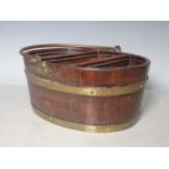 An oak and brass bound Basket with brass swing handle of oval shape with two dividers and painted