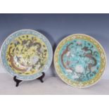 A pair of Chinese Chargers decorated dragons and flowers on blue and yellow grounds, 13¼in diam